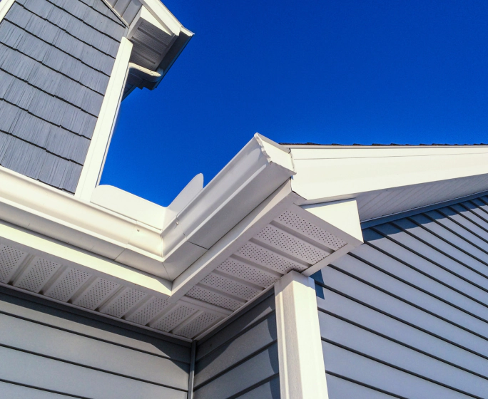 close up of the siding and gutters of a house